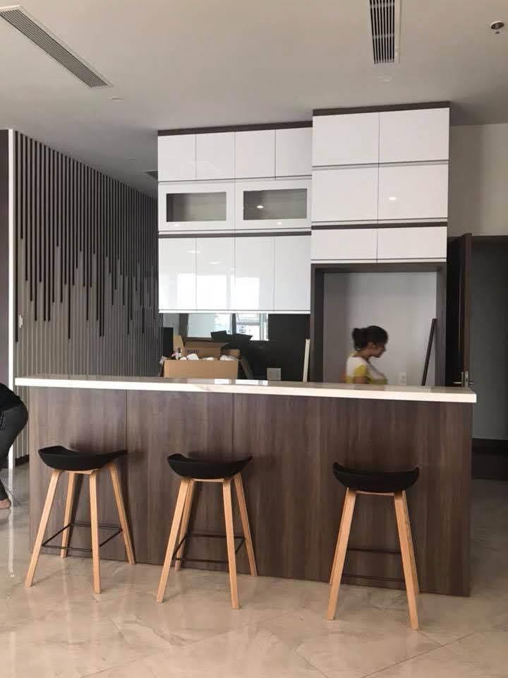 Modern kitchen with wooden bar stools.