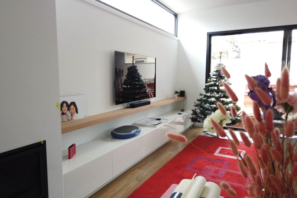 Modern living room with Christmas trees.